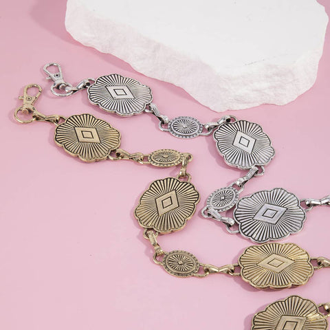  Decorative bracelet with gold and silver elements on a pink background