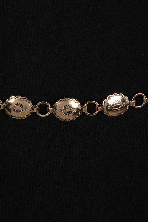  Gold bracelet with circular embellishments on a black background